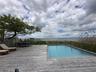 View of swimming pool featuring a wooden deck and outdoor dining area
