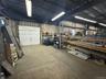 Garage with a workshop area and metal wall