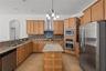 The spacious kitchen offers abundant cabinetry, generous workspace, and exceptional storage.