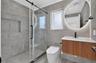 Shower with glass sliding door, built-in shower niche, and rain shower head