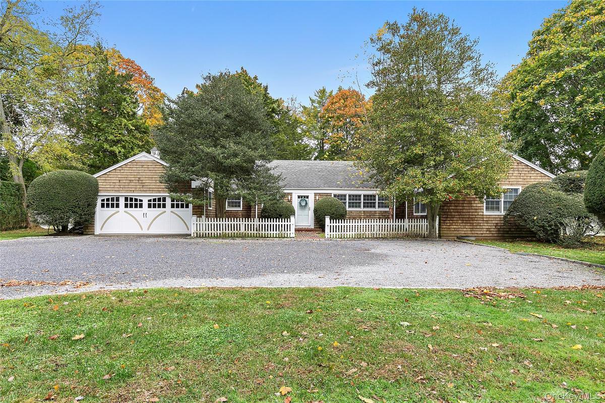 View of front of home featuring a garage and a front yard
