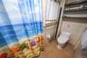 Full bathroom with tile patterned flooring, tile walls, and a shower with curtain