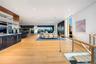 Living area with floor to ceiling windows, light wood finished floors, and recessed lighting