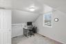 Office featuring vaulted ceiling and light colored carpet