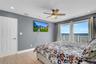 Bedroom featuring light wood-type flooring, access to exterior, a ceiling fan, and recessed lighting