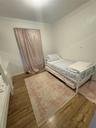 Bedroom with wood-type flooring and crown molding