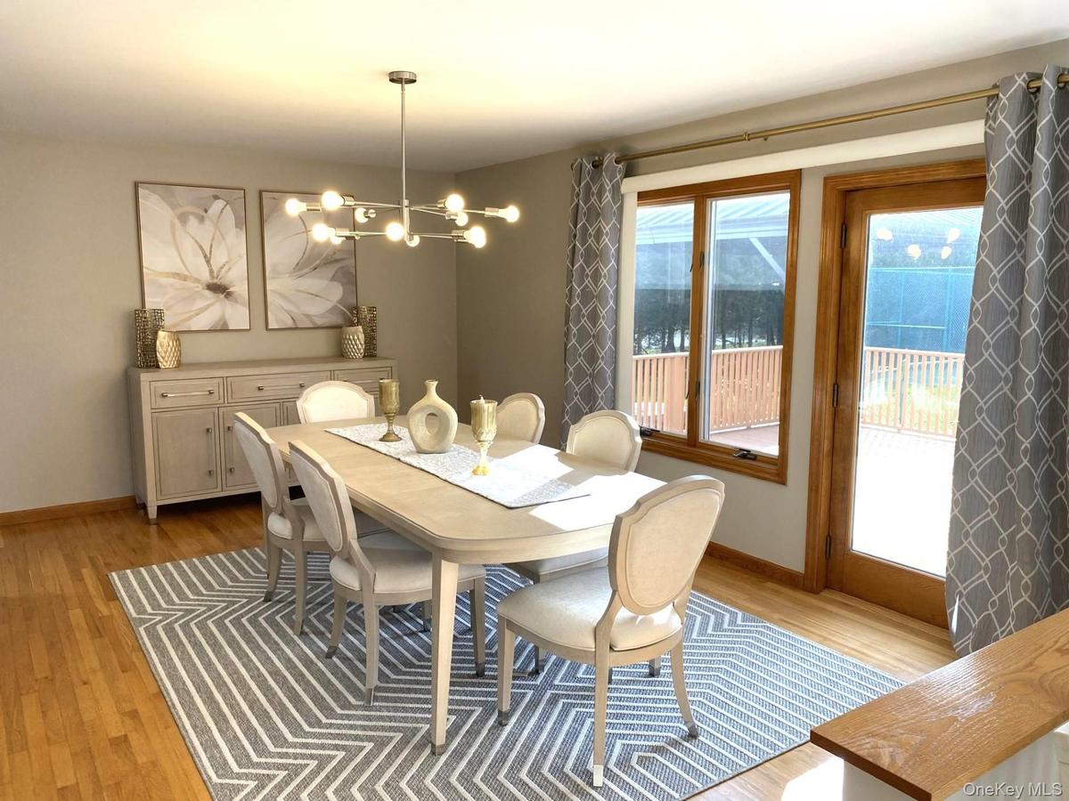 Dining room with light wood finished floors and a chandelier