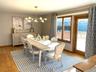 Dining room with light wood finished floors and a chandelier