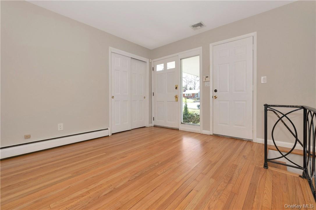 Entry Foyer, Door leads to two car garage, stairs lead to finished lower level
