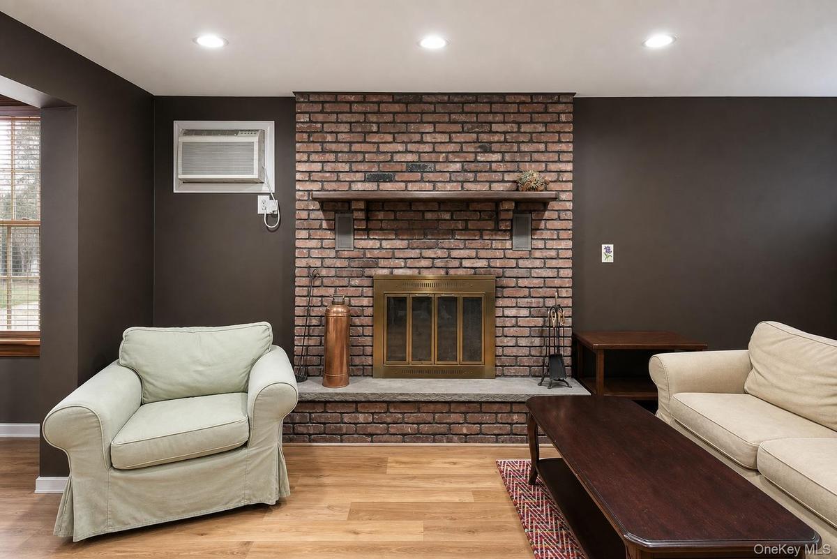 Brick fireplace with a stone hearth and wood mantel