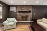 Brick fireplace with a stone hearth and wood mantel