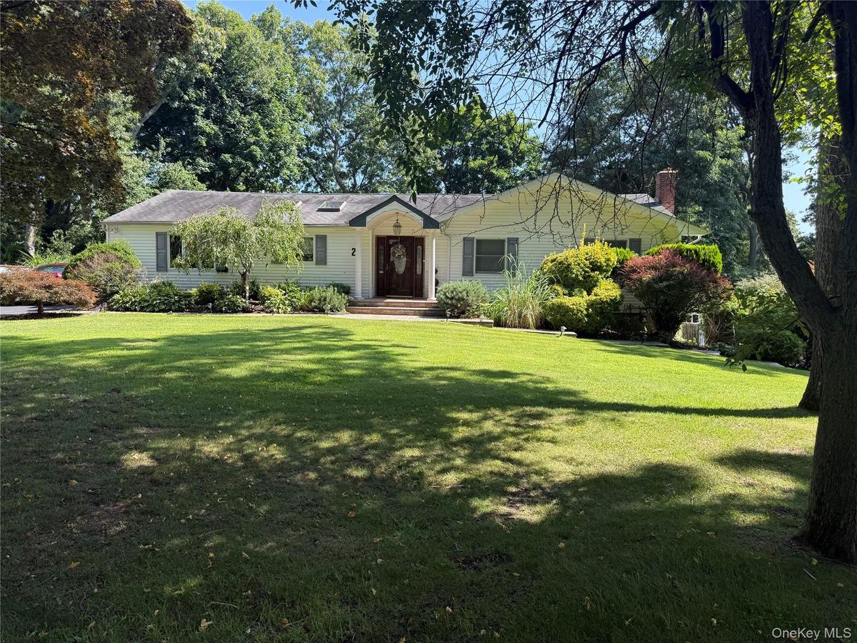 Spacious front yard with a large green lawn