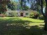 Spacious front yard with a large green lawn