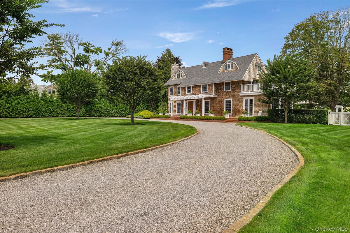 Beautiful expansive front yard with two entrances -circular driveway. Automatic Gates.
