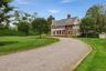 Beautiful expansive front yard with two entrances -circular driveway. Automatic Gates.