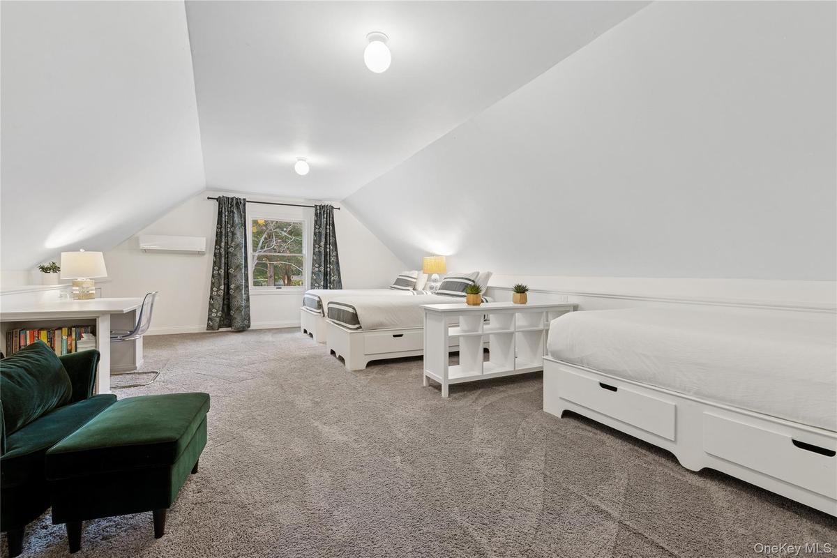 Carpeted bedroom featuring vaulted ceiling