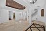 Living Room features a tray ceiling, travertine flooring & high ceilings