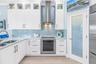 Upper Cabinets Extend to Ceiling with Lighted Display Cabinets