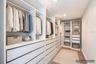 Primary Suite Closet/virtually staged with clothes only