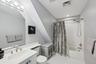 Full bathroom with tile patterned floors, vanity, toilet, and shower / bathtub combination with curtain