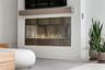 A dramatic gas fireplace with glass rocks and accent lighting create an atmosphere that feels both luxurious and inviting.