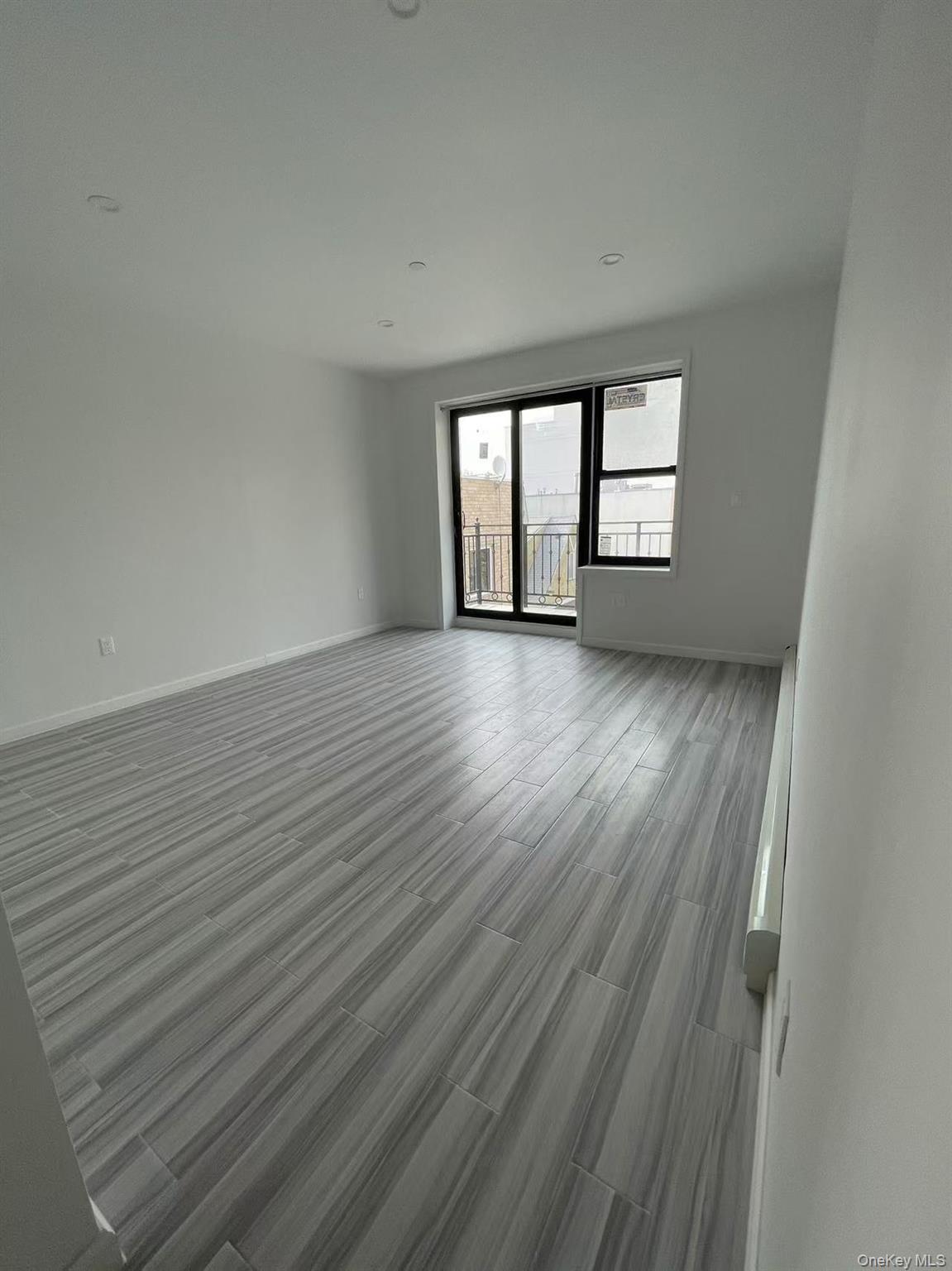Empty room with baseboards and wood finished floors