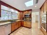 Large window keep kitchen light and bright with view of he sparkling pool.