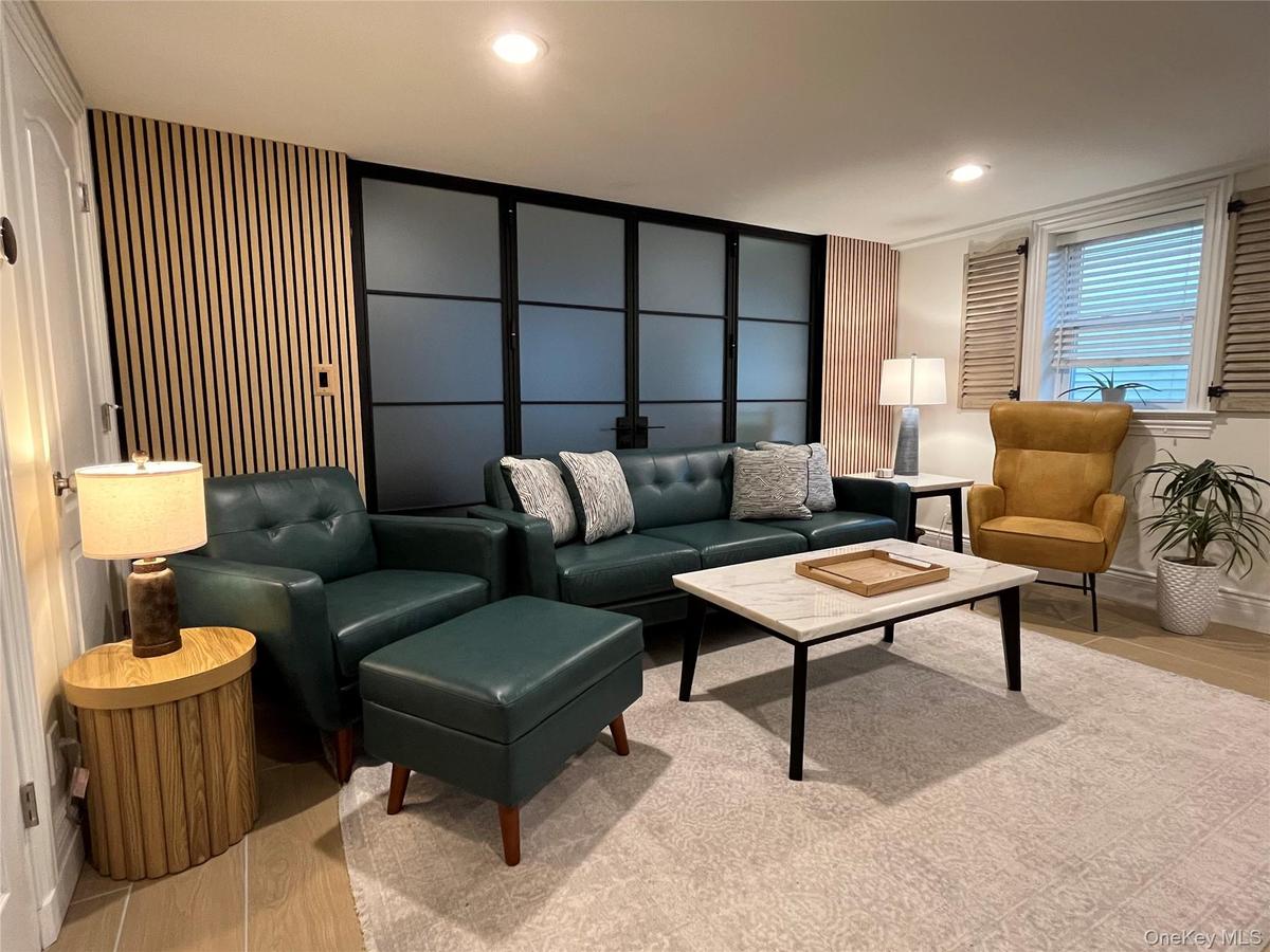 Living room featuring light wood-style flooring and recessed lighting