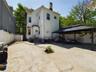 Back of property featuring a chimney, a patio, and a gazebo