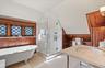 Bathroom with a shower stall, tile patterned flooring, a sink, and a soaking tub