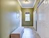 Hallway with entrance to garage and double pantries/closets