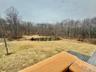 0 - View of yard featuring a wooded view and a water view from master bedroom