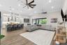 Spacious living room with dual oversized fans.
