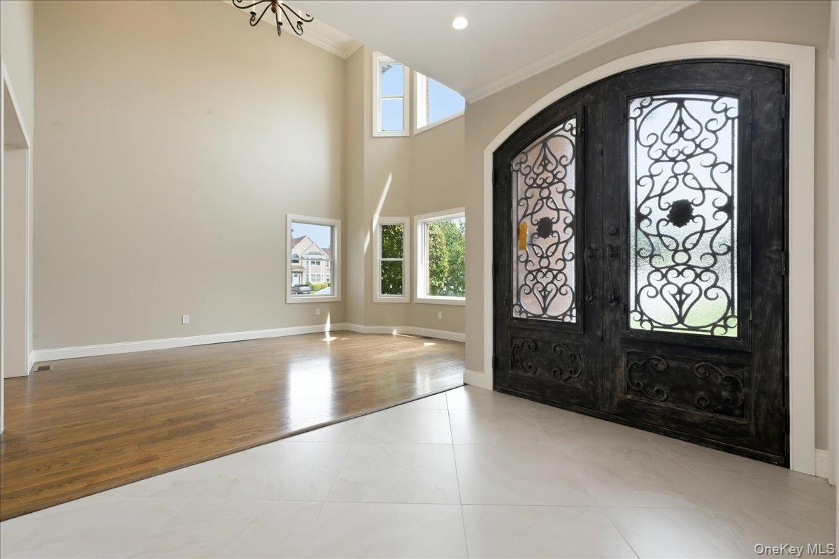 Grand double-door entry with decorative ironwork