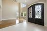 Grand double-door entry with decorative ironwork