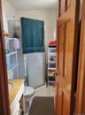 Bathroom with a shower stall, vanity, and light tile patterned floors