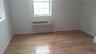 Spare room featuring light wood-style floors and a wall mounted air conditioner