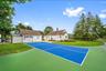 View of sport court with an outbuilding and a lawn