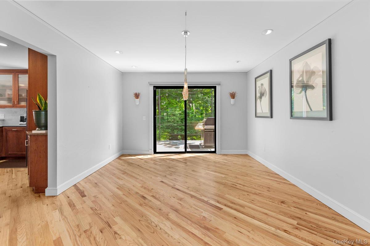 Unfurnished dining area featuring light wood finished floors, baseboards, and recessed lighting