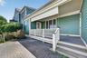 The side porch offers a quiet, more private place to sit, read, and enjoy the peaceful surroundings, with enough room to create a comfortable outdoor 