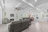 Soaring coffered ceiling and fireplace add elegance to the spacious living and dining rooms.