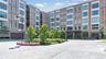 The welcoming front entrance to The Beacon features an elegant lobby entry flanked by convenient garage access on either side.