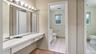 Bathroom with toilet, visible vents, tile patterned flooring, and baseboards