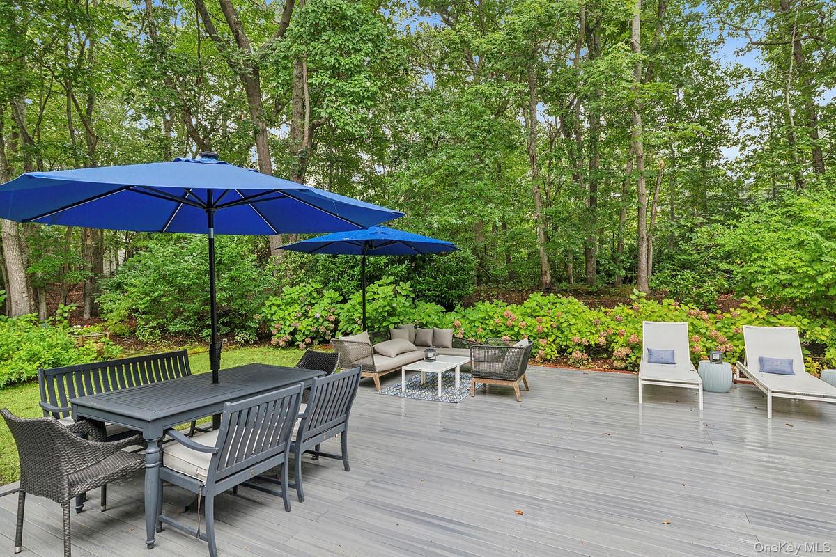 Wooden terrace featuring outdoor lounge area and outdoor dining space