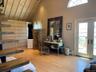 primary bedroom sitting room with terrace & stairs leading up to loft