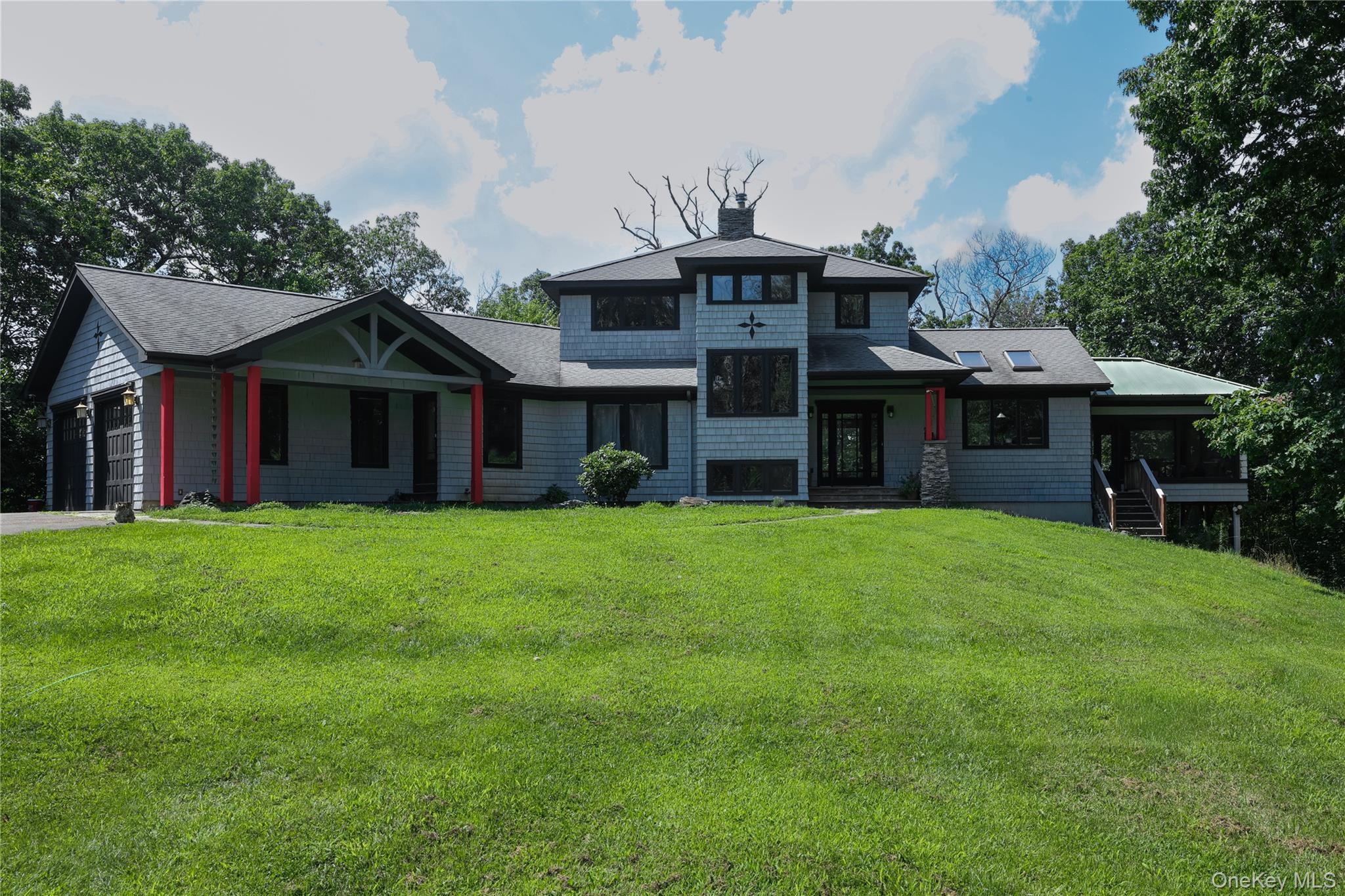 Contemporary architectural style with shingle siding and a multi-level roofline