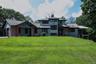 Contemporary architectural style with shingle siding and a multi-level roofline