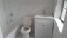 Bathroom with vanity, tile walls, and washtub / shower combination