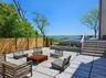 View of patio featuring a water view, an outdoor living space, and fence