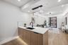 Kitchen with a sink, modern cabinets, a peninsula, light wood-type flooring, and recessed lighting